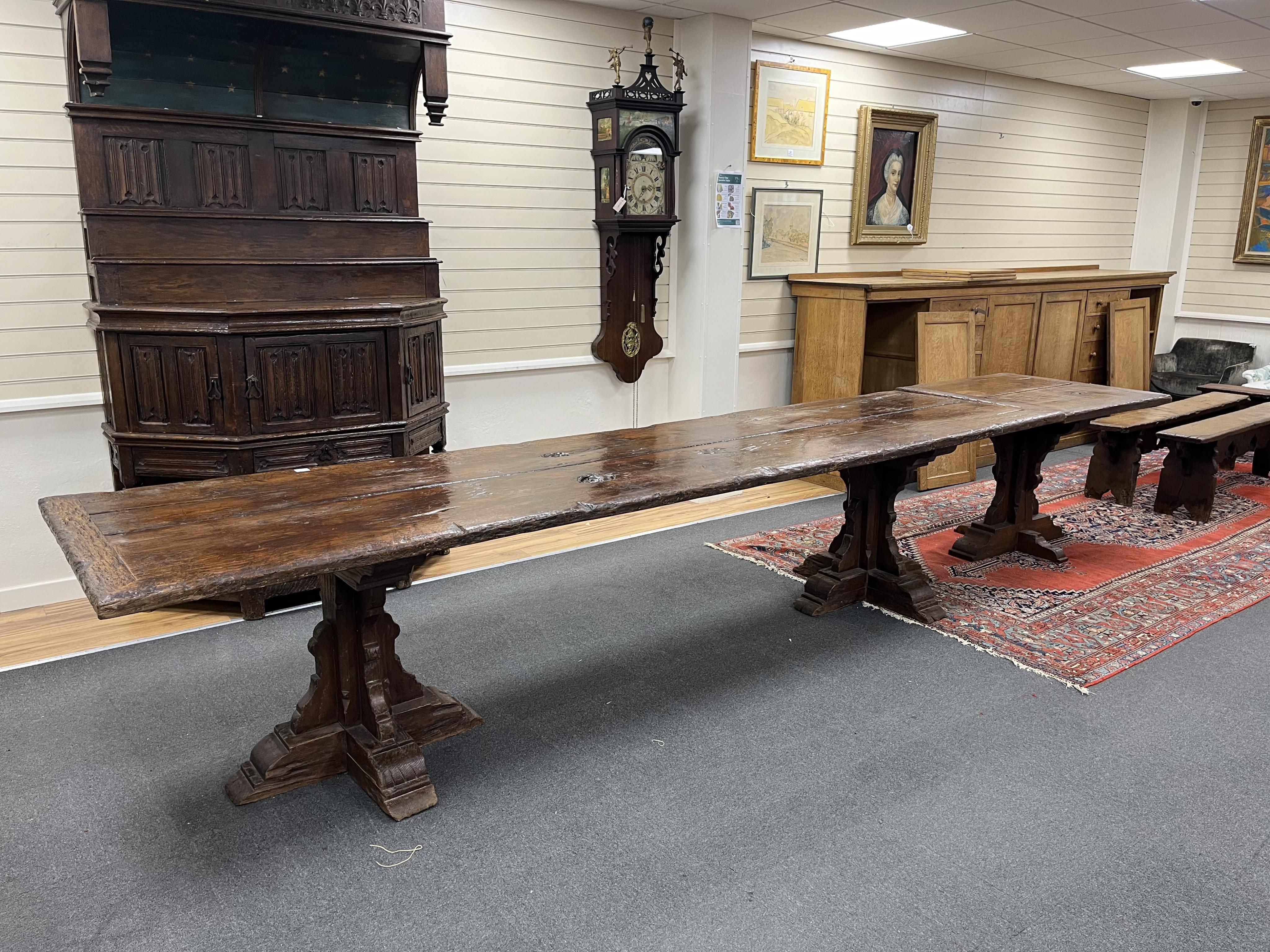 A long twin plank oak refectory dining table, in 15th century gothic style, cruciform twin pedestal base, with additional square extension table, length 365cm, 464cm with extension, depth 88cm, height 78cm. Condition - f